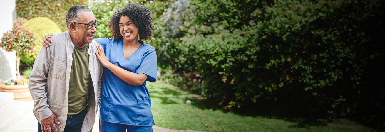 Caregiver and Patient Walking Outside Discussing NorthShore Benefits
